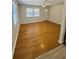 Bright living room featuring wood-look floors, a ceiling fan, and lots of natural light from the windows at 4111 W Grace St, Tampa, FL 33607