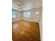 Inviting living room boasts wood-look flooring, modern ceiling fan, and large windows for ample lighting at 4111 W Grace St, Tampa, FL 33607