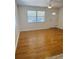 Spacious living room with wood-look floors, modern ceiling fan, and plenty of natural light at 4111 W Grace St, Tampa, FL 33607
