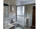 Tiled bathroom featuring a glass-enclosed shower and a vanity with a mirror at 432 Flamingo Dr, Apollo Beach, FL 33572