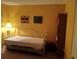 This bright bedroom has gold bed frame, colorful artwork, and carpeted floor at 432 Flamingo Dr, Apollo Beach, FL 33572