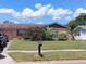 Charming single-story home with a well-maintained lawn and mature landscaping on a sunny day at 432 Flamingo Dr, Apollo Beach, FL 33572