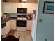 A well-lit kitchen with white cabinetry, black appliances, and tile flooring at 432 Flamingo Dr, Apollo Beach, FL 33572