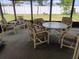 Enclosed patio featuring neutral striped furniture and table set, creating a relaxing outdoor space at 432 Flamingo Dr, Apollo Beach, FL 33572
