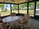Enjoy outdoor dining on this enclosed patio with a dining table, seating and backyard views at 432 Flamingo Dr, Apollo Beach, FL 33572