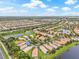 Beautiful aerial view of a well-planned community with lakes, lush landscaping, and manicured lawns at 4911 Rock Island Ct, Wimauma, FL 33598