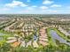Panoramic aerial view of a picturesque community featuring lakes, lush landscaping, and tile roofs at 4911 Rock Island Ct, Wimauma, FL 33598