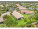An aerial view of a large lot with mature landscaping, lush green grass, and a screened in lanai at 4911 Rock Island Ct, Wimauma, FL 33598