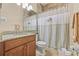 Inviting bathroom with a vanity, granite countertop, and a tiled shower and tub at 4911 Rock Island Ct, Wimauma, FL 33598