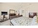 Bright bedroom featuring neutral walls, ceiling fan, and comfortable queen bed at 4911 Rock Island Ct, Wimauma, FL 33598
