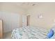 Bedroom offering natural light, a ceiling fan, carpet floors, and a double door closet at 4911 Rock Island Ct, Wimauma, FL 33598