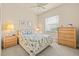 Cozy bedroom featuring a bed, a window with blinds, and a wooden dresser at 4911 Rock Island Ct, Wimauma, FL 33598