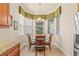 Bright breakfast nook with large windows, chandelier, and tile flooring at 4911 Rock Island Ct, Wimauma, FL 33598