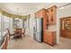 Bright breakfast nook with stainless fridge and wooden cabinets at 4911 Rock Island Ct, Wimauma, FL 33598