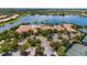 An aerial view of the community clubhouse with a swimming pool, tennis court and covered parking at 4911 Rock Island Ct, Wimauma, FL 33598
