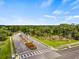 A view of the community entrance with lush landscaping and a waterfall feature on a sunny day at 4911 Rock Island Ct, Wimauma, FL 33598