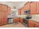 Modern kitchen with stainless steel appliances, granite counters, and ample cabinet space at 4911 Rock Island Ct, Wimauma, FL 33598