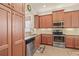 Well-lit kitchen featuring stainless steel appliances, tiled backsplash, and granite countertops at 4911 Rock Island Ct, Wimauma, FL 33598