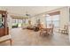 Open living and dining area featuring tile floors and sliding glass doors to the lanai at 4911 Rock Island Ct, Wimauma, FL 33598