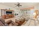 Comfortable living room with leather and tan sofas with view to backyard at 4911 Rock Island Ct, Wimauma, FL 33598