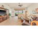 Comfortable living room with tan sofas and view to backyard at 4911 Rock Island Ct, Wimauma, FL 33598