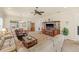 Open-concept living room with tile flooring, ceiling fan, and ample seating at 4911 Rock Island Ct, Wimauma, FL 33598