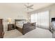 Bright primary bedroom features plush carpet, a ceiling fan, and decorative art at 4911 Rock Island Ct, Wimauma, FL 33598