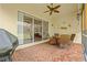 Charming patio with brick flooring, ceiling fan, outdoor dining set, and decorative wall art at 4911 Rock Island Ct, Wimauma, FL 33598
