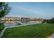 Well-manicured backyard with lush green grass, a small dock, and bay views in the background at 501 Barcelona Dr, Tierra Verde, FL 33715