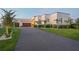 Modern home with paver driveway, manicured lawn, and lush landscaping at 501 Barcelona Dr, Tierra Verde, FL 33715