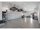 Spacious garage with high ceilings, storage racks and parking for multiple vehicles at 501 Barcelona Dr, Tierra Verde, FL 33715