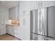 Modern kitchen featuring stainless steel refrigerator, sleek cabinets, and counter lighting at 501 Barcelona Dr, Tierra Verde, FL 33715