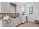 Well-lit laundry room with modern washer and dryer and plenty of storage at 501 Barcelona Dr, Tierra Verde, FL 33715