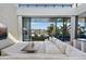 Bright living room features a view of the waterfront and sliding glass doors to the lanai at 501 Barcelona Dr, Tierra Verde, FL 33715