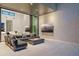 Modern living room featuring comfortable sofa, gas fireplace, and two wall mounted televisions at 501 Barcelona Dr, Tierra Verde, FL 33715