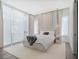 Beautifully staged bedroom with floor to ceiling drapes, neutral colors and luxury furnishings at 501 Barcelona Dr, Tierra Verde, FL 33715