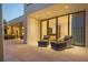 Spacious outdoor patio with modern seating and an outdoor kitchen overlooking the backyard at 501 Barcelona Dr, Tierra Verde, FL 33715
