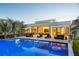 Stunning backyard with modern pool, comfortable lounge furniture, and lush tropical landscaping at 501 Barcelona Dr, Tierra Verde, FL 33715