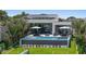 Modern backyard pool featuring stylish lounge seating and lush green lawn at 501 Barcelona Dr, Tierra Verde, FL 33715