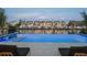 Luxury infinity pool overlooking calm bay waters and waterfront homes in the distance at 501 Barcelona Dr, Tierra Verde, FL 33715
