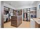 Large walk-in closet with custom shelving, plenty of storage, and a center island at 501 Barcelona Dr, Tierra Verde, FL 33715