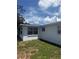 The exterior view of the house with a yard at 5025 Tammy Ln, Holiday, FL 34690