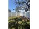Backyard with a tall white fence and a large tree in the background at 5025 Tammy Ln, Holiday, FL 34690