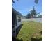 View of the backyard with a lawn and a tall white fence at 5025 Tammy Ln, Holiday, FL 34690