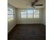 Bright bedroom features updated vinyl floors and a ceiling fan, creating a comfortable and inviting atmosphere at 5025 Tammy Ln, Holiday, FL 34690