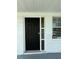 Close-up of a black front door with decorative glass and house number 5025 at 5025 Tammy Ln, Holiday, FL 34690