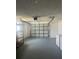 Spacious garage featuring an automatic door, storage shelves and a washing machine at 5025 Tammy Ln, Holiday, FL 34690
