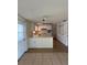 Bright kitchen features white cabinets, tile countertops, and essential appliances for convenient meal preparation at 5025 Tammy Ln, Holiday, FL 34690