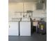 Functional laundry area with a washing machine, dryer, utility sink, and water heater at 5025 Tammy Ln, Holiday, FL 34690