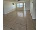 Open living room features neutral walls and tile flooring, offering a versatile space for relaxation and entertainment at 5025 Tammy Ln, Holiday, FL 34690